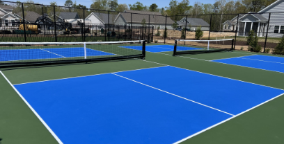 A vivid blue and green tennis court in a residential community
